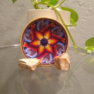 This is a wooden bowl with beads